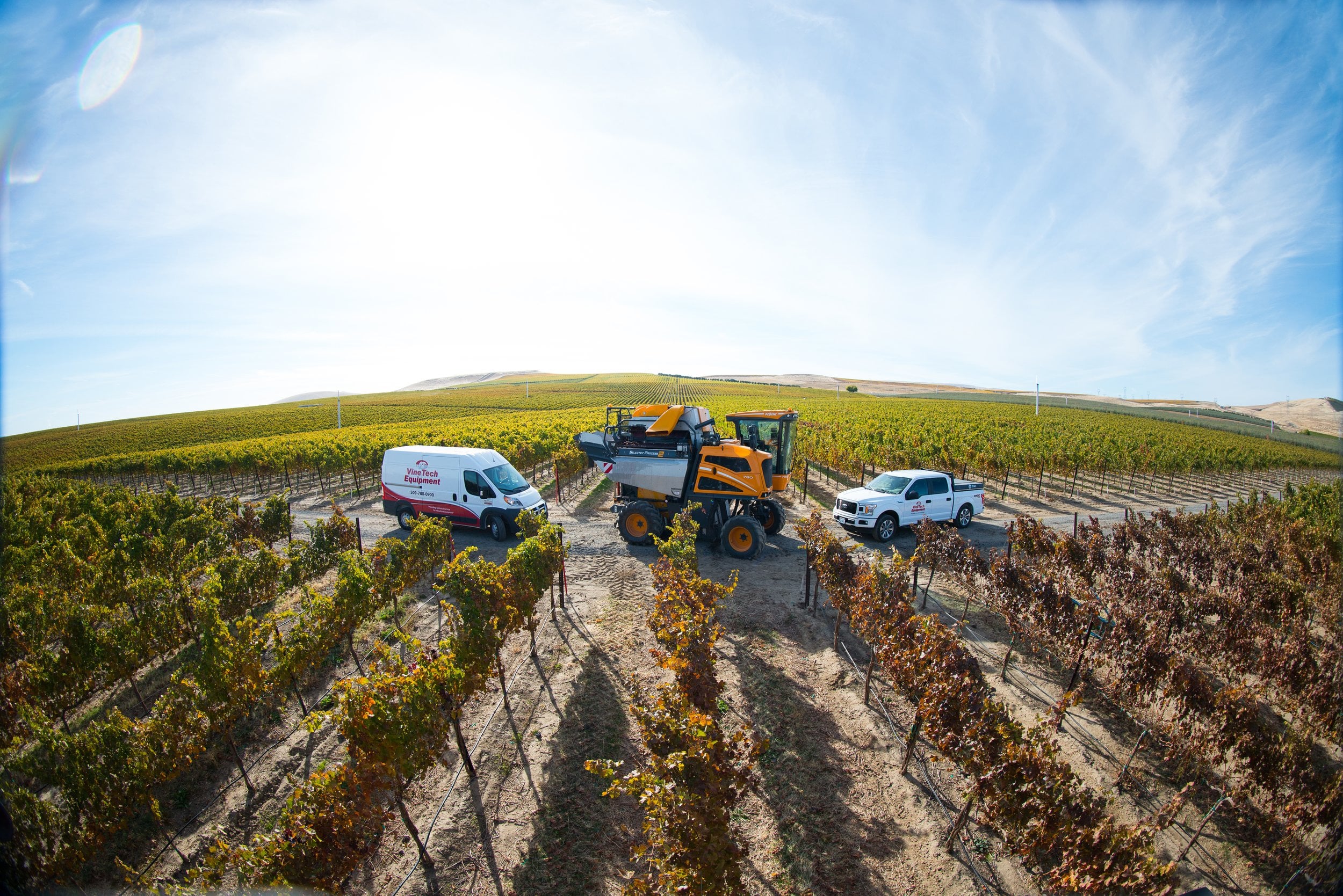 Vine Tech service van, harvester and truck in a vineyard